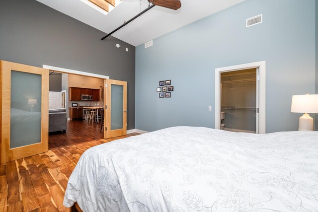 403 State St Unit 6, Saint Joseph, MI 49085 - bedroom with high vaulted ceiling, wood finished floors, a spacious closet, a ceiling fan, and a closet