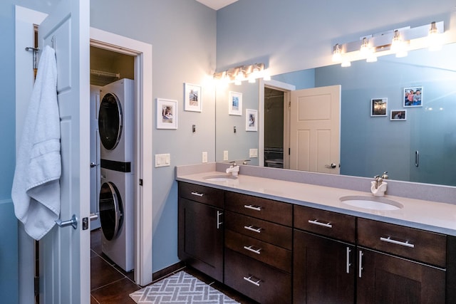 403 State St Unit 6, Saint Joseph, MI 49085 - bathroom with stacked washer / dryer, double vanity, and tile patterned flooring