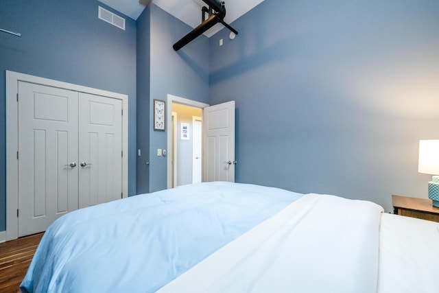 403 State St Unit 6, Saint Joseph, MI 49085 - bedroom with dark wood-style flooring, a high ceiling, and a closet