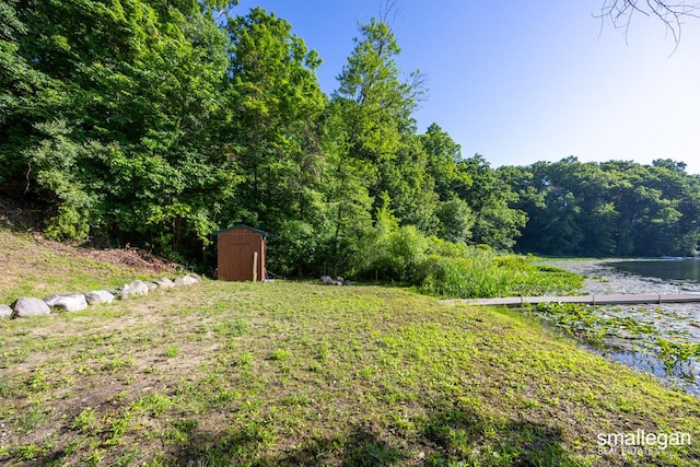 3192 W Sisson Rd, Freeport, MI 49325 - view of yard featuring a shed, a water view, and a view of trees