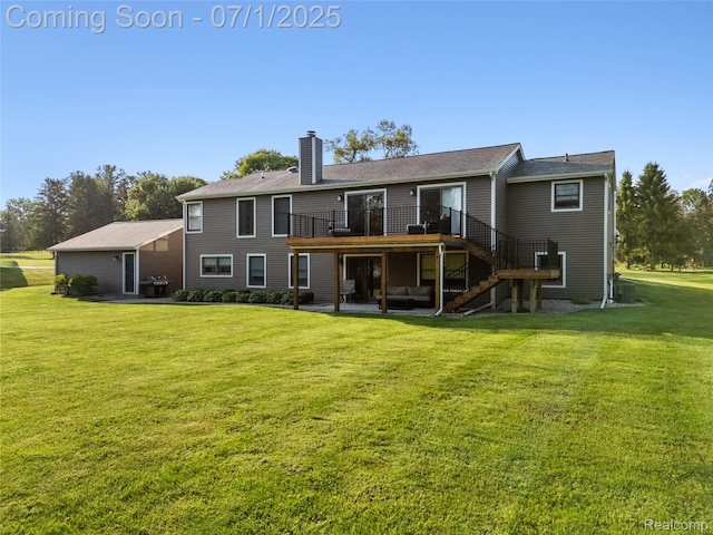 5131 Navajo Trl, Pinckney, MI 48169 - back of property with a deck, stairs, a chimney, a patio, and a yard
