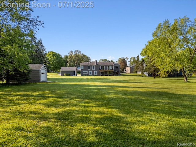 5131 Navajo Trl, Pinckney, MI 48169 - view of green lawn featuring a storage unit and a detached garage