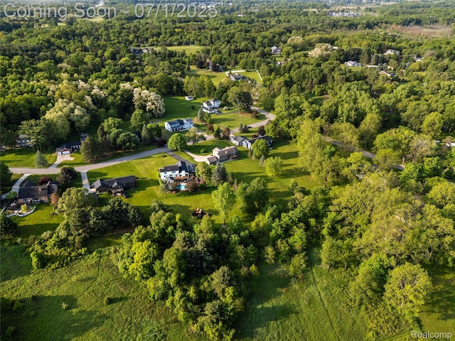 5131 Navajo Trl, Pinckney, MI 48169 - aerial view of property and surrounding area featuring a heavily wooded area