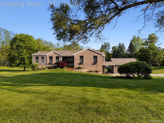 5131 Navajo Trl, Pinckney, MI 48169 - view of front of house with brick siding and a front lawn