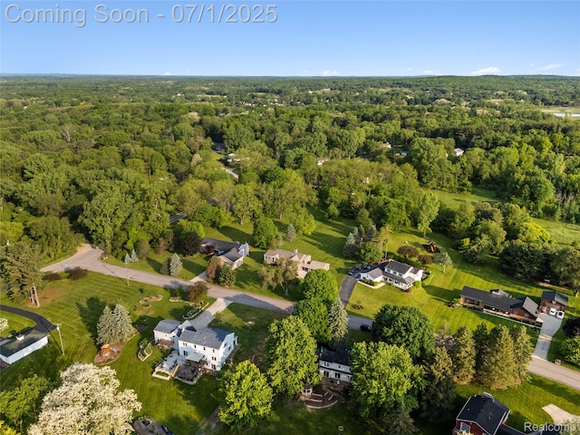 5131 Navajo Trl, Pinckney, MI 48169 - aerial view of property and surrounding area featuring a heavily wooded area