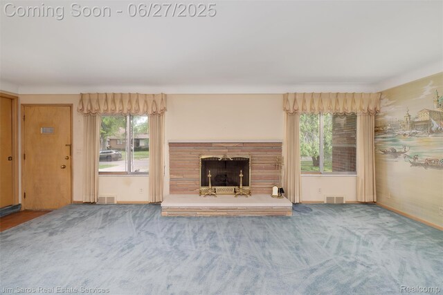 693 Anita Ave, Grosse Pointe Woods, MI 48236 - unfurnished living room with carpet, a fireplace with raised hearth, and plenty of natural light