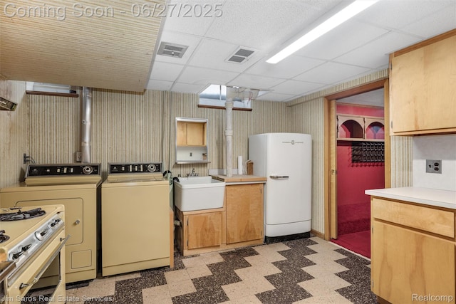 693 Anita Ave, Grosse Pointe Woods, MI 48236 - kitchen featuring fridge, washer and clothes dryer, light floors, light countertops, and a drop ceiling