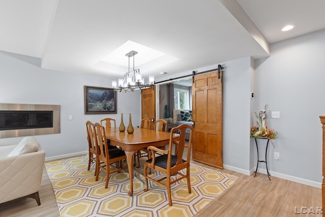 680 Breyman Hwy, Tipton, MI 49287 - dining room featuring light wood-style flooring, a chandelier, a barn door, and recessed lighting