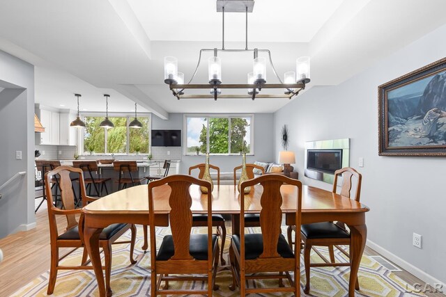680 Breyman Hwy, Tipton, MI 49287 - dining area featuring a chandelier and light wood finished floors