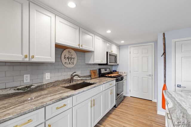 680 Breyman Hwy, Tipton, MI 49287 - kitchen with appliances with stainless steel finishes, white cabinets, tasteful backsplash, and recessed lighting