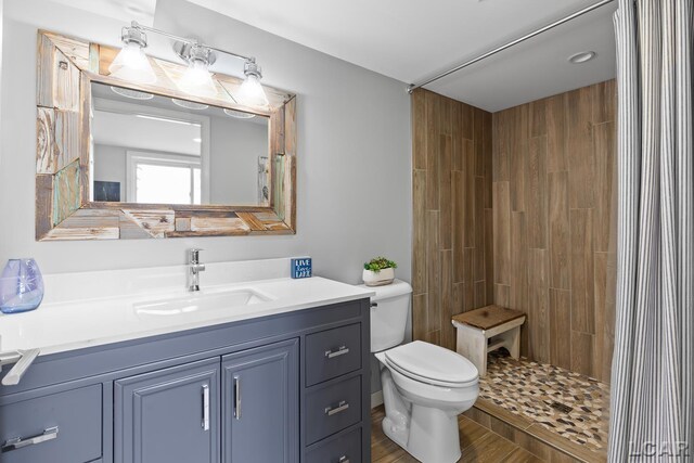 680 Breyman Hwy, Tipton, MI 49287 - full bath featuring vanity, a tile shower, and wood finished floors