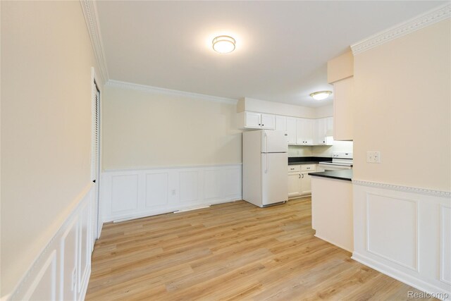10228 Nancys Blvd Unit 33, Grosse Ile, MI 48138 - kitchen with white appliances, a decorative wall, ornamental molding, dark countertops, and white cabinetry