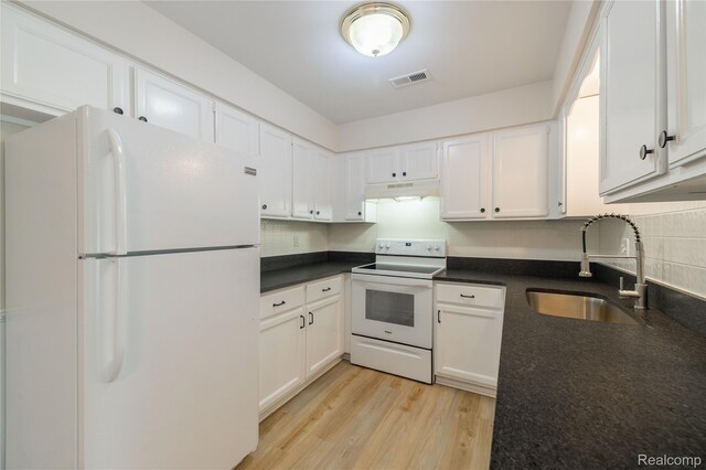 10228 Nancys Blvd Unit 33, Grosse Ile, MI 48138 - kitchen with white appliances, under cabinet range hood, dark countertops, and white cabinets