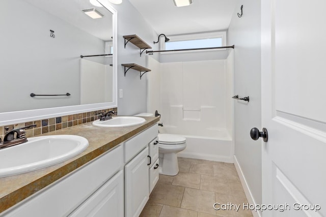 950 Whitetail Ct, Ionia, MI 48846 - bathroom featuring double vanity, shower / bathtub combination, tile patterned flooring, and decorative backsplash