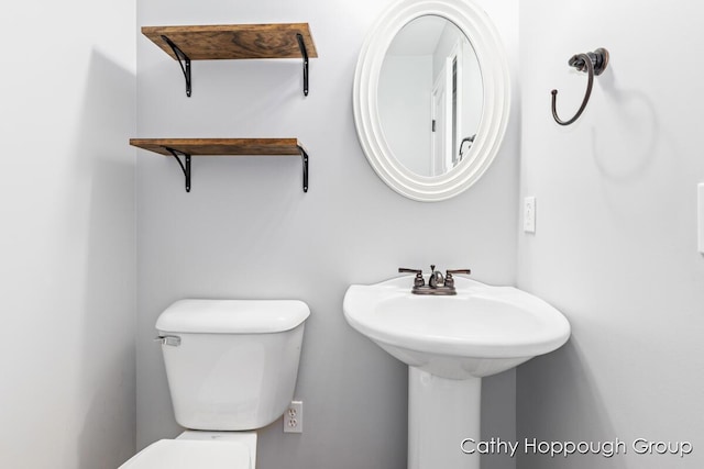 950 Whitetail Ct, Ionia, MI 48846 - bathroom featuring toilet and a sink