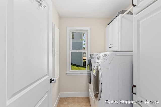 950 Whitetail Ct, Ionia, MI 48846 - laundry area featuring washing machine and clothes dryer and cabinet space