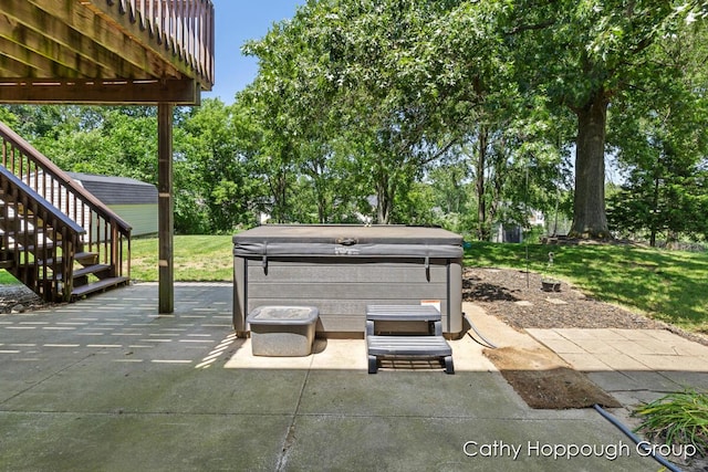950 Whitetail Ct, Ionia, MI 48846 - view of patio with a hot tub, stairway, and view of wooded area