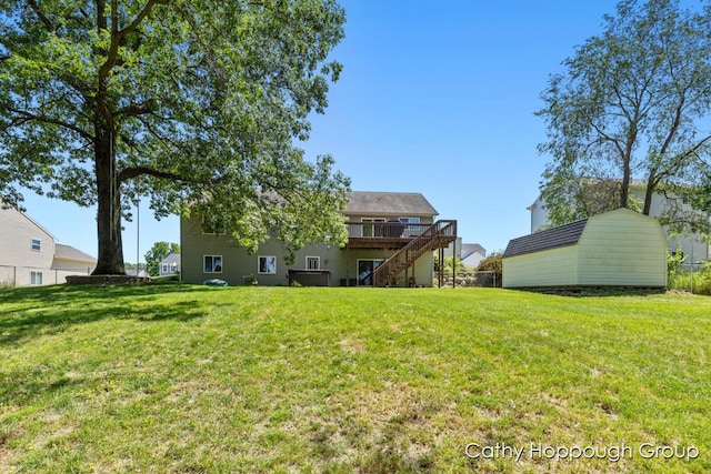 950 Whitetail Ct, Ionia, MI 48846 - view of grassy yard featuring stairway, a wooden deck, and a shed