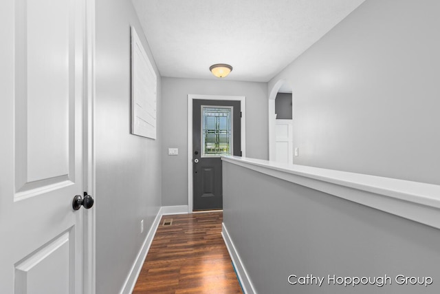 950 Whitetail Ct, Ionia, MI 48846 - doorway to outside with dark wood-style flooring and arched walkways