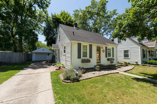 1608 Cambridge Dr, Kalamazoo, MI 49001 - view of front of house with an outdoor structure, a detached garage, a chimney, and a shingled roof