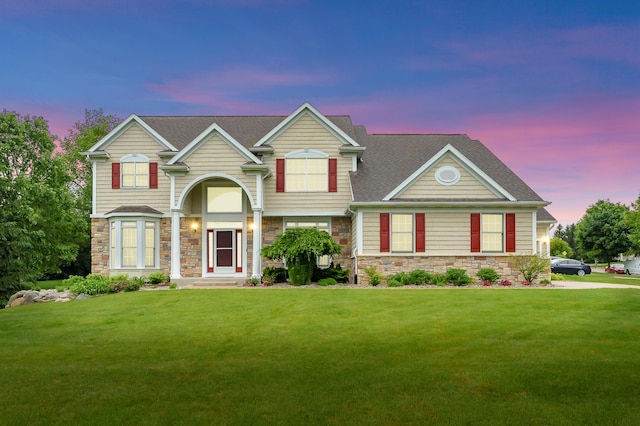 6380 Mcgillicuddy Ln, Portage, MI 49024 - view of front of home featuring stone siding, a lawn, and a shingled roof