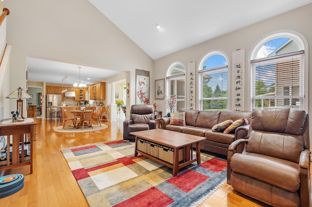 6380 Mcgillicuddy Ln, Portage, MI 49024 - living area with high vaulted ceiling, light wood-type flooring, a chandelier, and recessed lighting