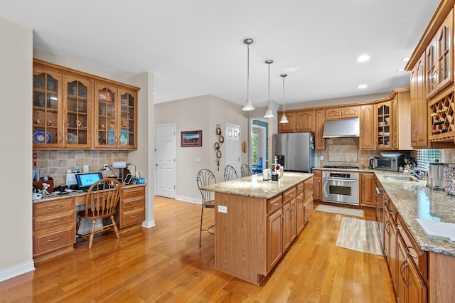 6380 Mcgillicuddy Ln, Portage, MI 49024 - kitchen featuring stainless steel appliances, under cabinet range hood, backsplash, light wood-style flooring, and recessed lighting