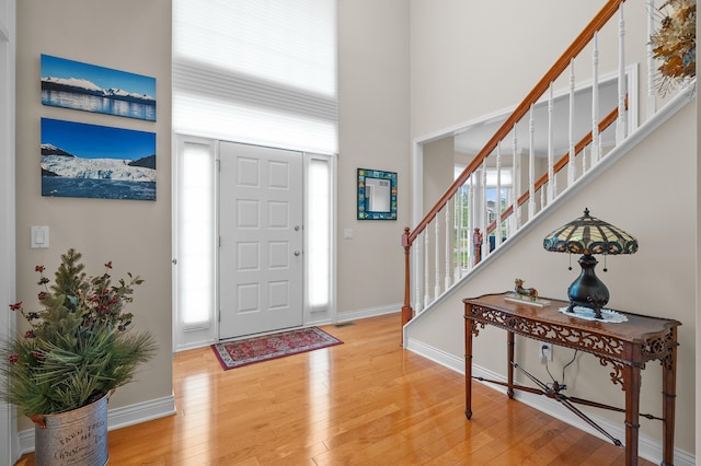 6380 Mcgillicuddy Ln, Portage, MI 49024 - entryway with plenty of natural light, light wood-style flooring, a towering ceiling, and stairs