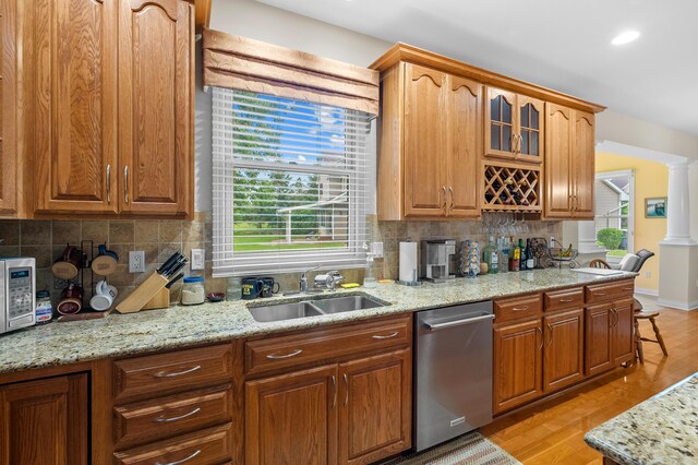 6380 Mcgillicuddy Ln, Portage, MI 49024 - kitchen featuring stainless steel dishwasher, plenty of natural light, glass insert cabinets, light stone countertops, and recessed lighting