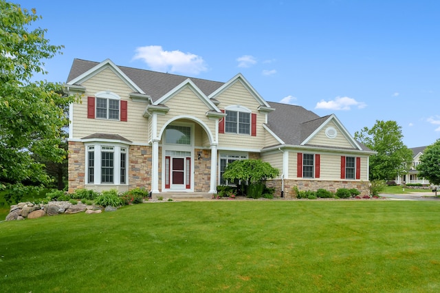 6380 Mcgillicuddy Ln, Portage, MI 49024 - view of front of home with stone siding, a front lawn, and a shingled roof