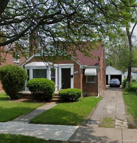 18328 Rosemont Ave, Detroit, MI 48219 - bungalow-style home with a garage, brick siding, a front yard, and driveway