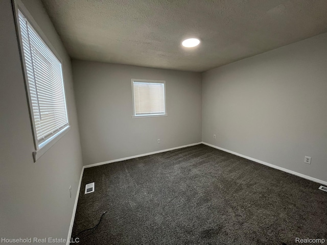 14722 Lydia Ave, Eastpointe, MI 48021 - unfurnished room with dark colored carpet and a textured ceiling