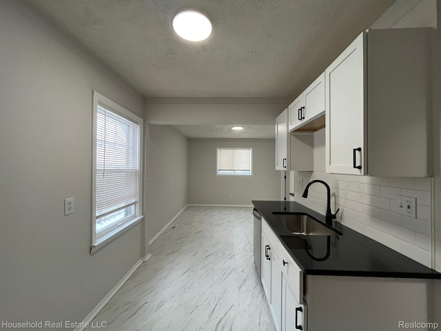 14722 Lydia Ave, Eastpointe, MI 48021 - kitchen with dark countertops, a textured ceiling, tasteful backsplash, and white cabinets