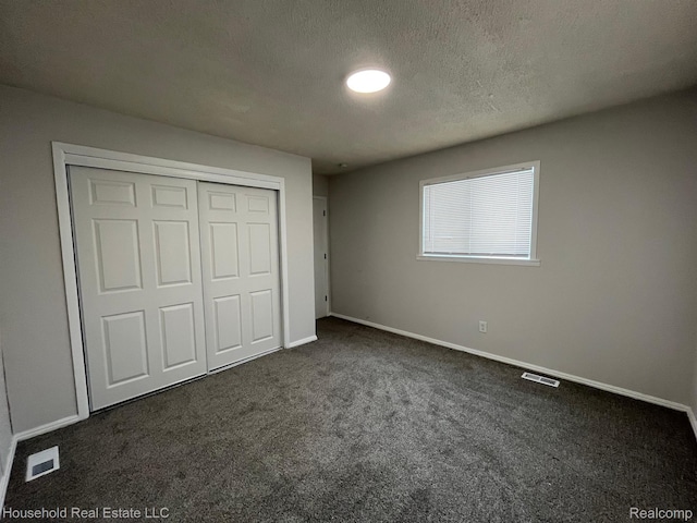 14722 Lydia Ave, Eastpointe, MI 48021 - unfurnished bedroom featuring dark colored carpet, a closet, and a textured ceiling