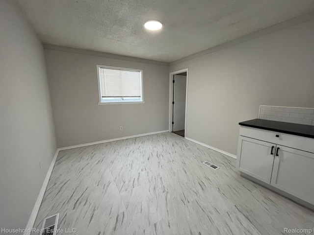 14722 Lydia Ave, Eastpointe, MI 48021 - unfurnished room featuring a textured ceiling and baseboards
