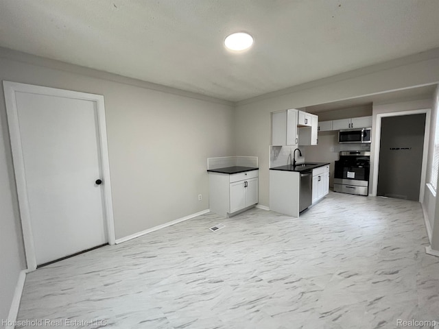 14722 Lydia Ave, Eastpointe, MI 48021 - kitchen featuring appliances with stainless steel finishes, white cabinetry, and dark countertops