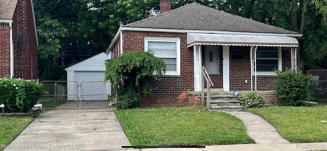 14722 Lydia Ave, Eastpointe, MI 48021 - bungalow-style home with a shingled roof, a chimney, brick siding, concrete driveway, and an outdoor structure