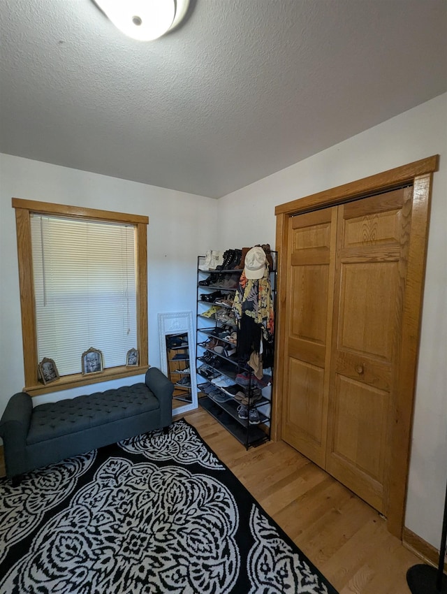 2740 Booth Rd, Au Gres, MI 48703 - bedroom featuring light wood-style flooring and a textured ceiling