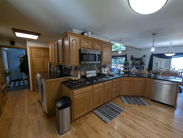 2740 Booth Rd, Au Gres, MI 48703 - kitchen with appliances with stainless steel finishes, light wood-type flooring, decorative backsplash, a peninsula, and a ceiling fan