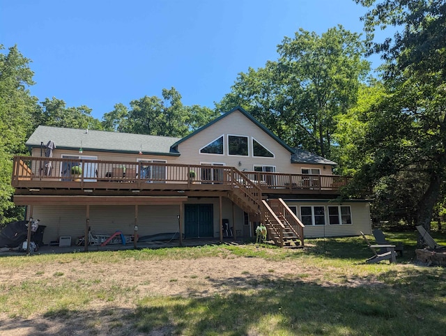 2740 Booth Rd, Au Gres, MI 48703 - rear view of property featuring stairway, a wooden deck, and a lawn