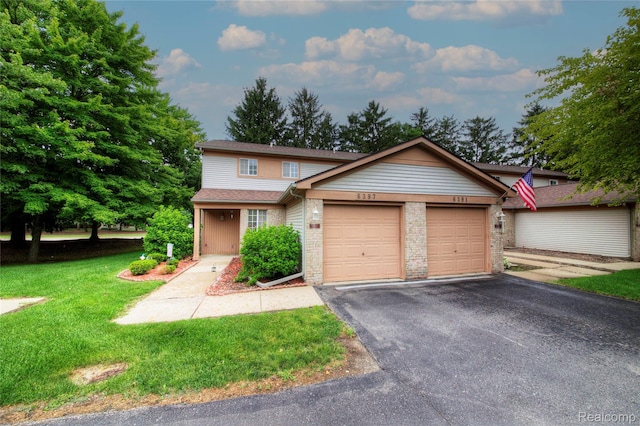 6397 Hunter Pointe St, Westland, MI 48185 - view of front of property featuring a garage, driveway, a front yard, brick siding, and roof with shingles