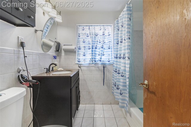 3901 Westpoint St, Dearborn Heights, MI 48125 - bathroom with tile walls, vanity, tile patterned flooring, and shower / tub combo