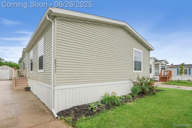 26317 Cherokee E, Flat Rock, MI 48134 - view of home's exterior with a lawn and a shed