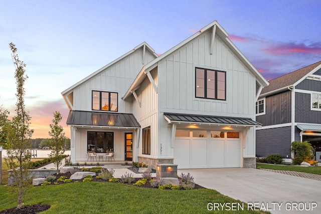 1351 Bayview Dr, Holland, MI 49423 - modern farmhouse style home with a standing seam roof, an attached garage, concrete driveway, a metal roof, and board and batten siding