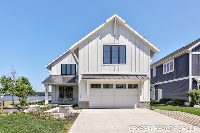 1351 Bayview Dr, Holland, MI 49423 - modern farmhouse style home with board and batten siding, a standing seam roof, driveway, and a water view