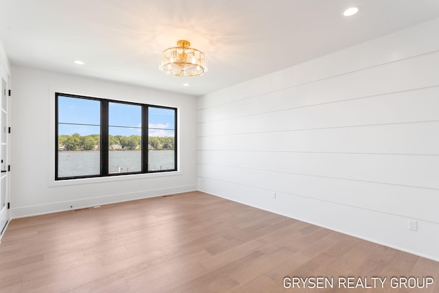 1351 Bayview Dr, Holland, MI 49423 - empty room with recessed lighting, a chandelier, and light wood-type flooring