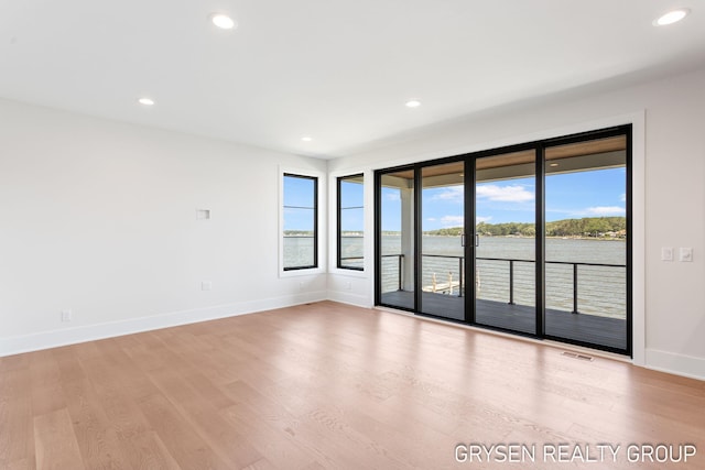1351 Bayview Dr, Holland, MI 49423 - spare room featuring light wood finished floors, recessed lighting, and a water view