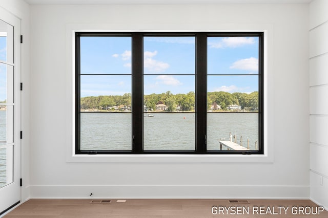 1351 Bayview Dr, Holland, MI 49423 - spare room with healthy amount of natural light, a water view, and light wood-type flooring