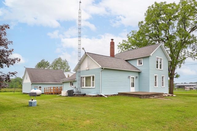 8075 Caine Rd, Millington, MI 48746 - rear view of house with a chimney, a lawn, and a shingled roof