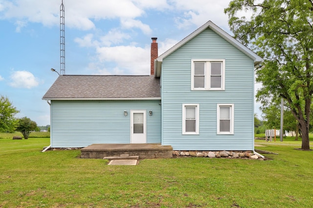 8075 Caine Rd, Millington, MI 48746 - rear view of property with a yard, a chimney, and roof with shingles